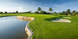 A golf course beside a lake.
