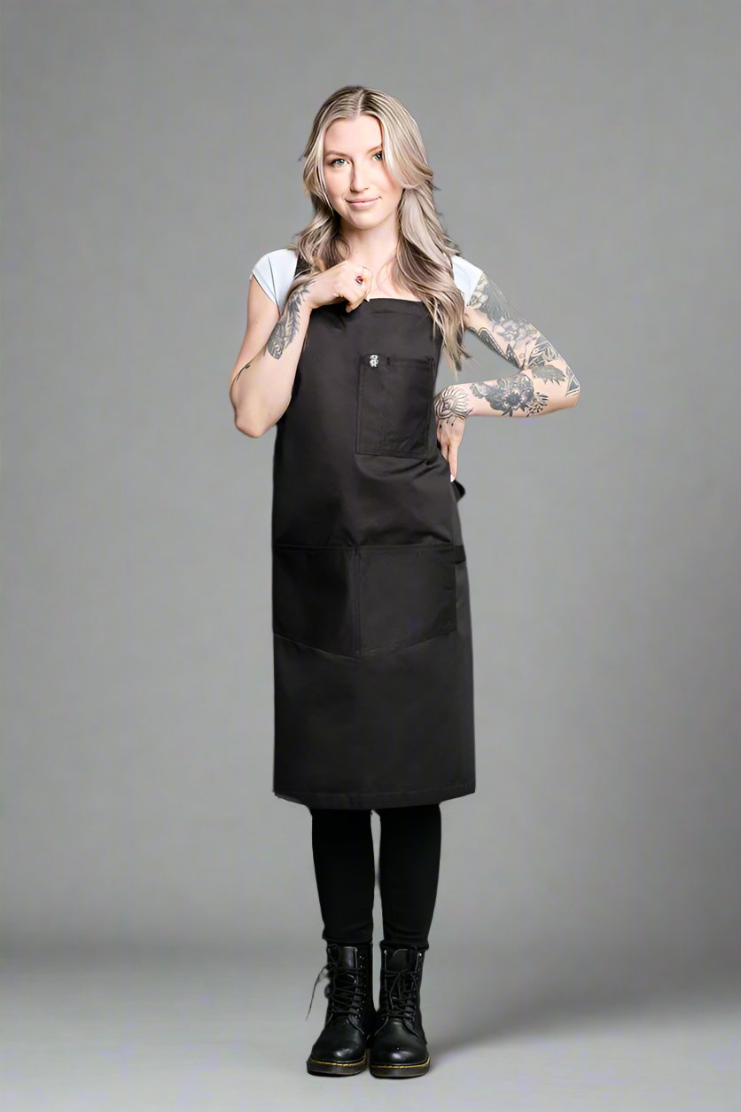 The black Gold Label Strathcona apron shown on a model.
