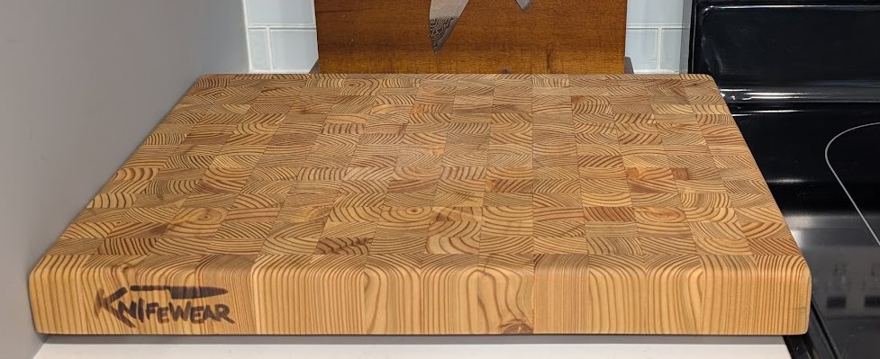 An end-grain cutting board from KnifeWear on the kitchen counter.