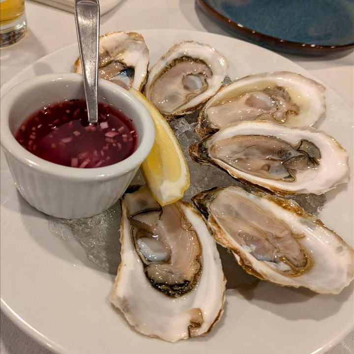 Fresh oysters served with lemon and sauce.