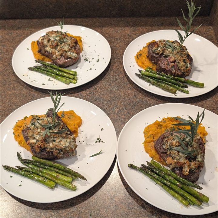 Several plated entrees prepared for a group.