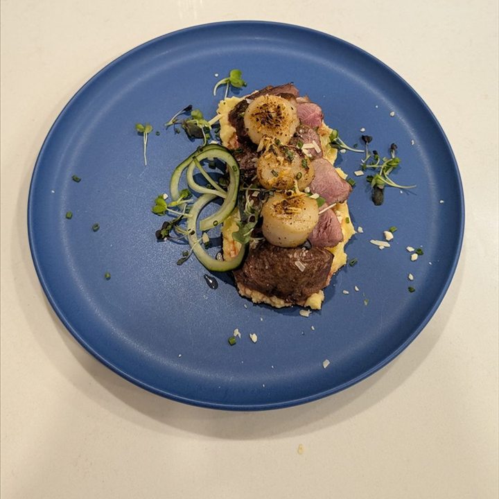 A plated main course with pasta and vegetables.