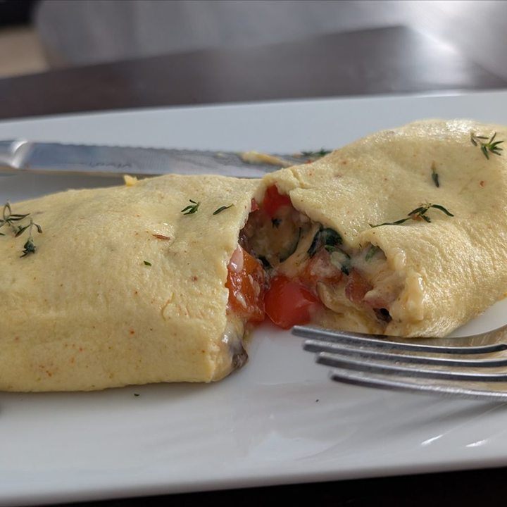 An omelet cut open to show its filling.