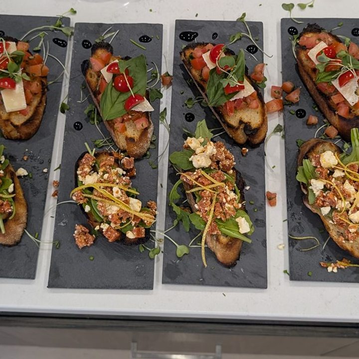 Rows of small toast appetizers arranged on serving trays.
